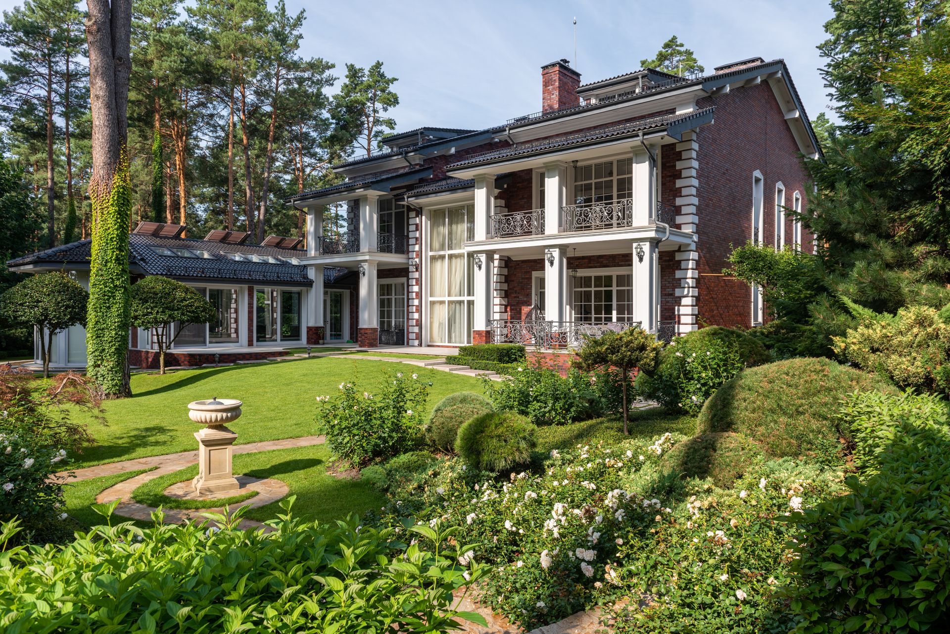 Manicured garden with lush lawns and established plantings around a home